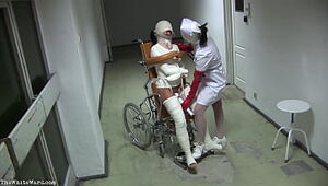 Patient in Wheelchair with Battered Gams and Straight jacket - TheWhiteWard.com